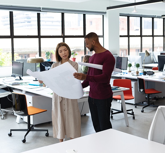 two professionals looking for plans for a commercial space