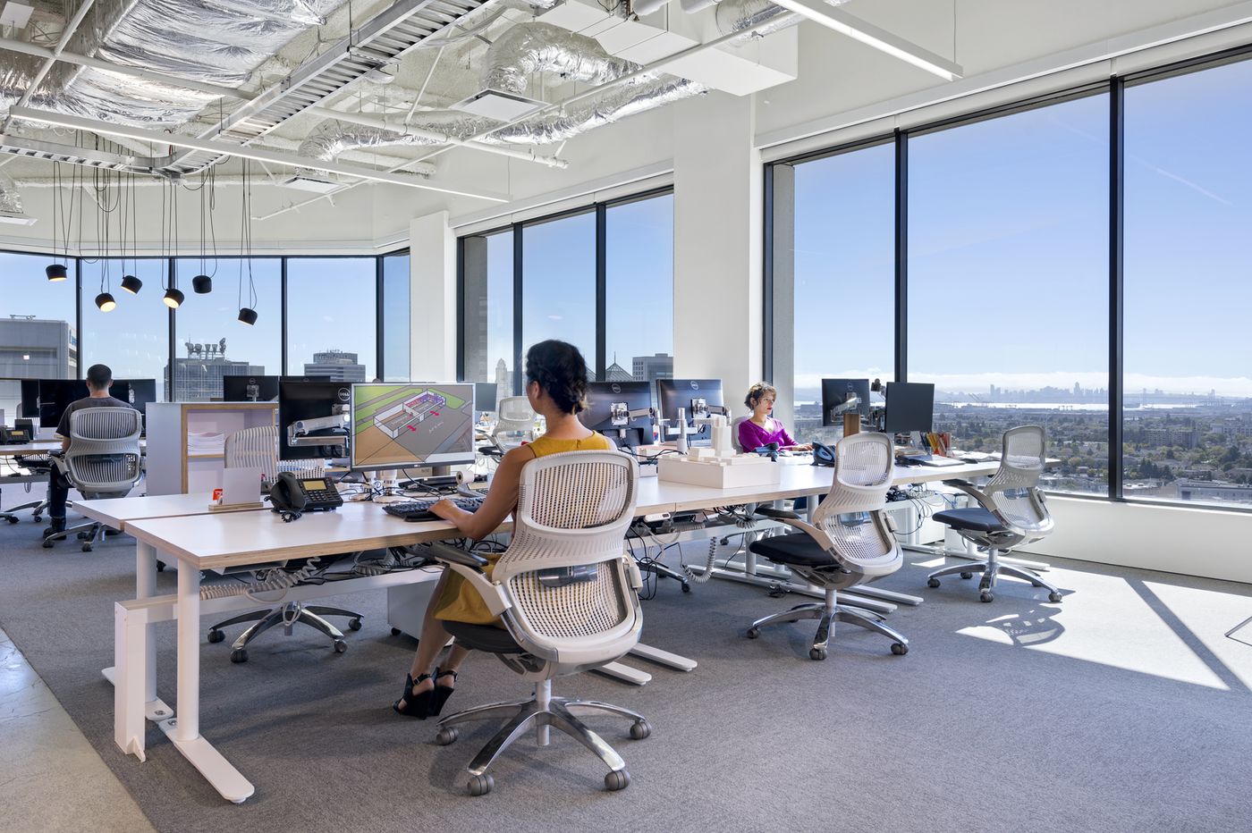 Employees utilizing their open floor plan to operate their business